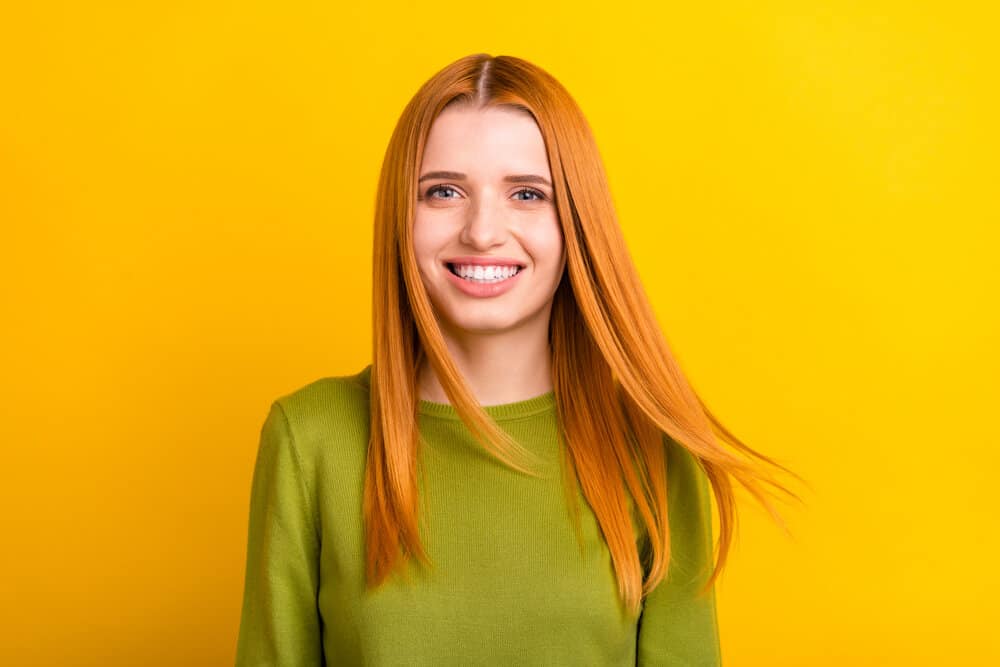 Woman with lovely red human hair that has been moisturized with natural oils and hair products designed for white girls.