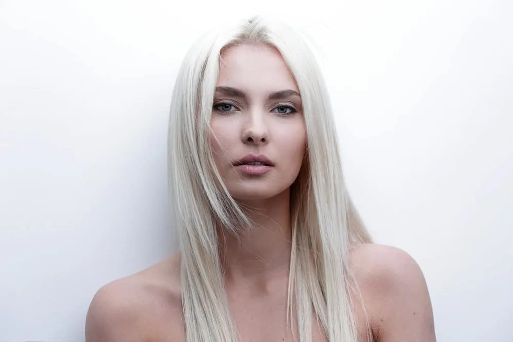 How to Get Platinum Blonde Hair from Golden Blonde at Home 1 A cute young white girl wearing her platinum hair blonde after having toned it with purple shampoo.