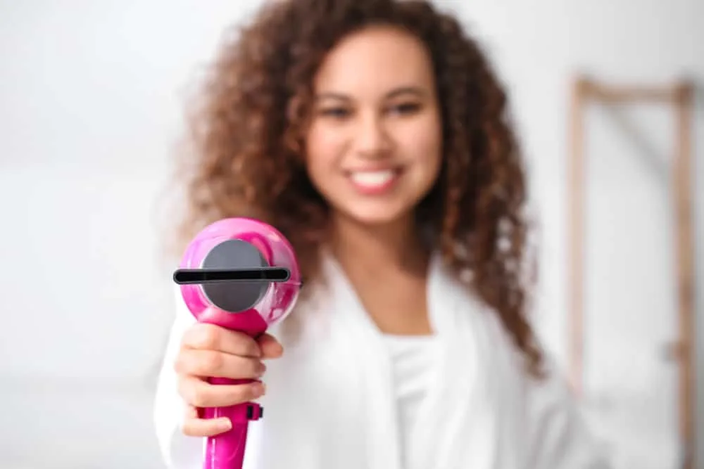How Hot Does a Hair Dryer Get in Fahrenheit and Celsius 4 A lady holding one of the newer ionic hair dryers measures the average temperature that the hair shaft will experience.