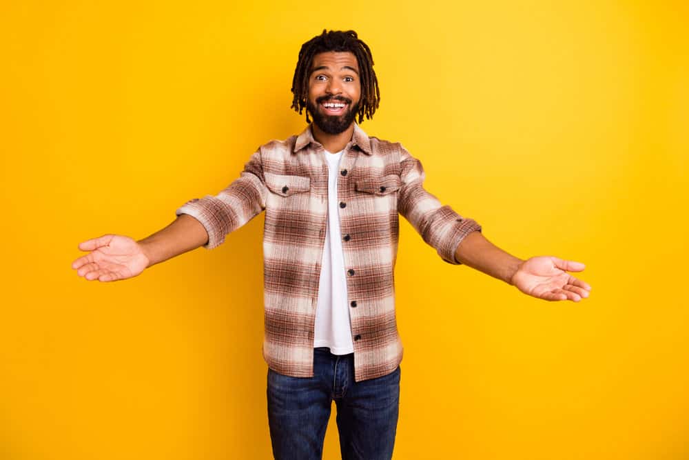 African American male with free-form dreadlocks that are similar to the locs worn by the famous rapper - Playboi Carti.