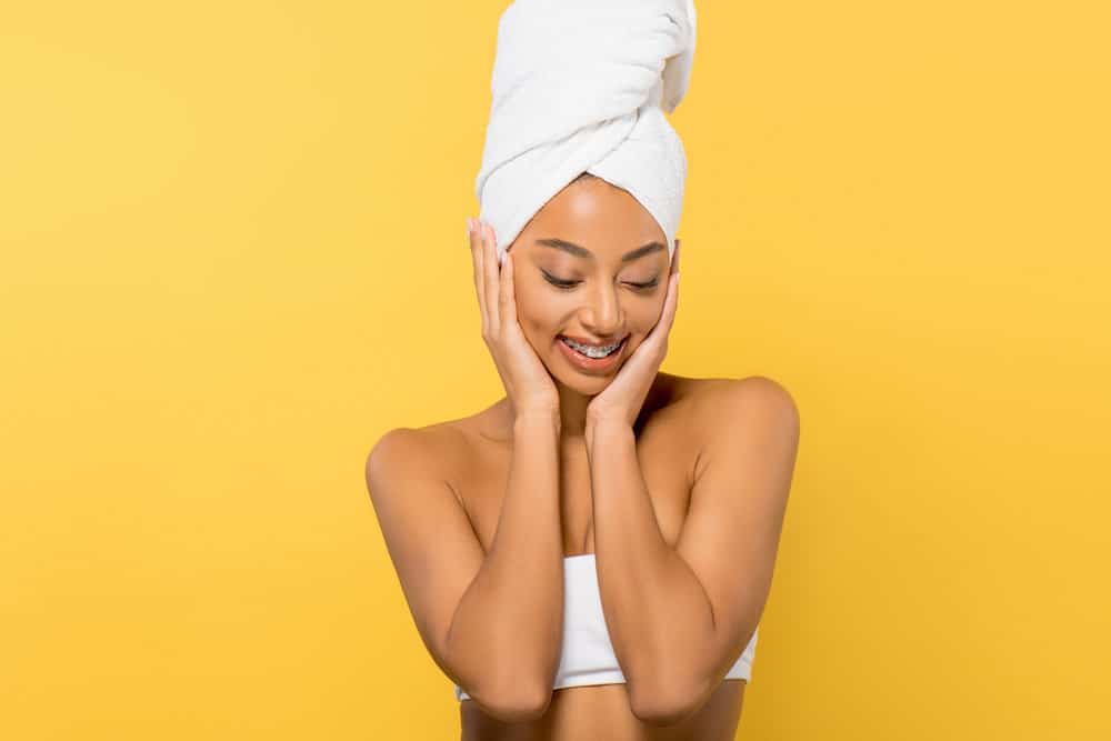 African American female that used leave-in hair products before plopping using the head and flip technique.