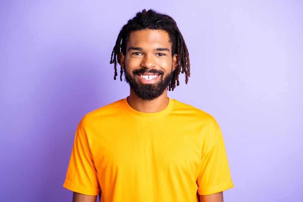 Young African American guy wearing Lil Durk dreads which started out as two strand twists with rubber bands.