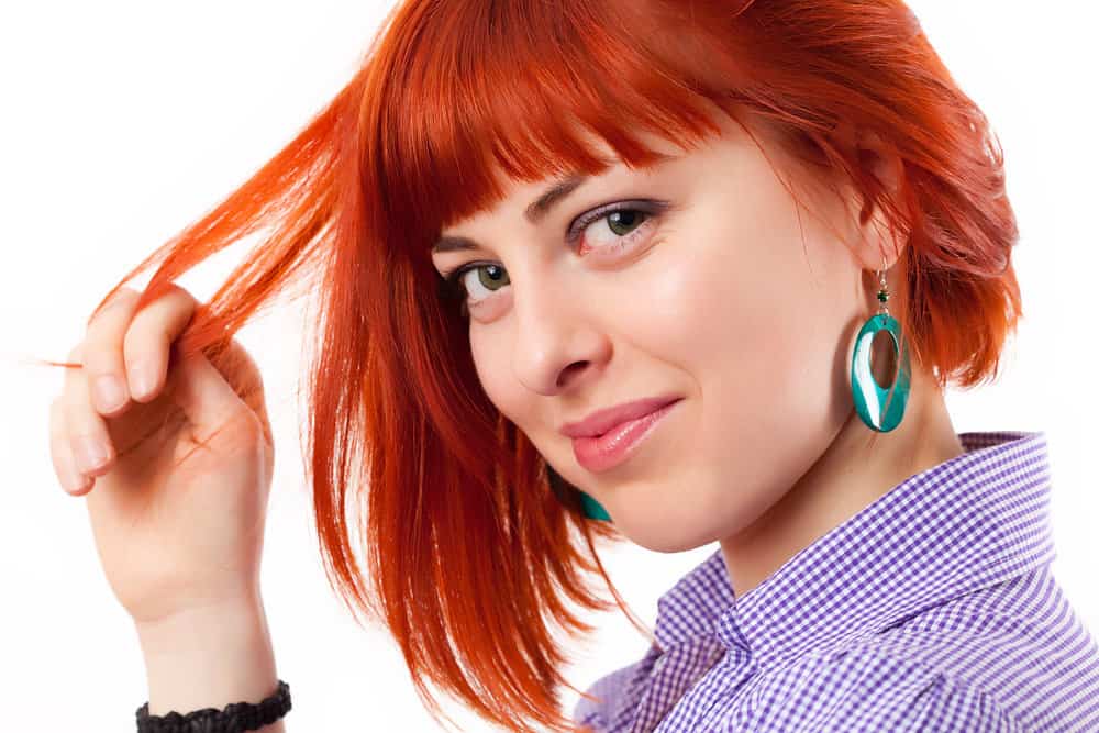 A female with red Splat dye over medium brown darker hair creates a vibrant color with semi-permanent hair color.