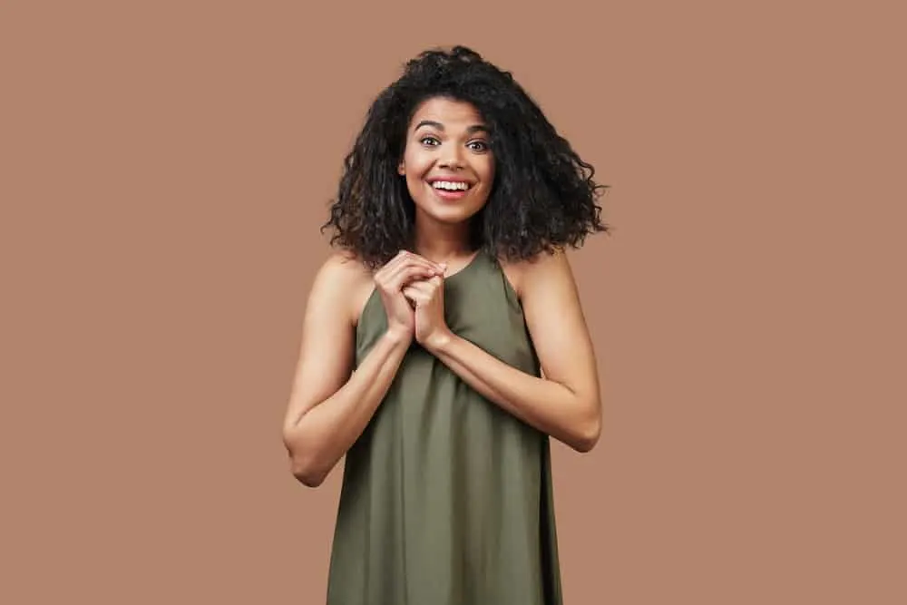 How to Get Curly Hair Back After Straightening It Too Much 9 Beautiful young African woman's natural curls returned after getting a hair straightening treatment.