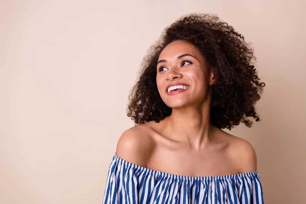 What Developer to Use to Darken Hair and Why? 10, 20, 30? 11 Positive female with a great smile wearing natural dyed curls styled with cream developer and natural color pigments.