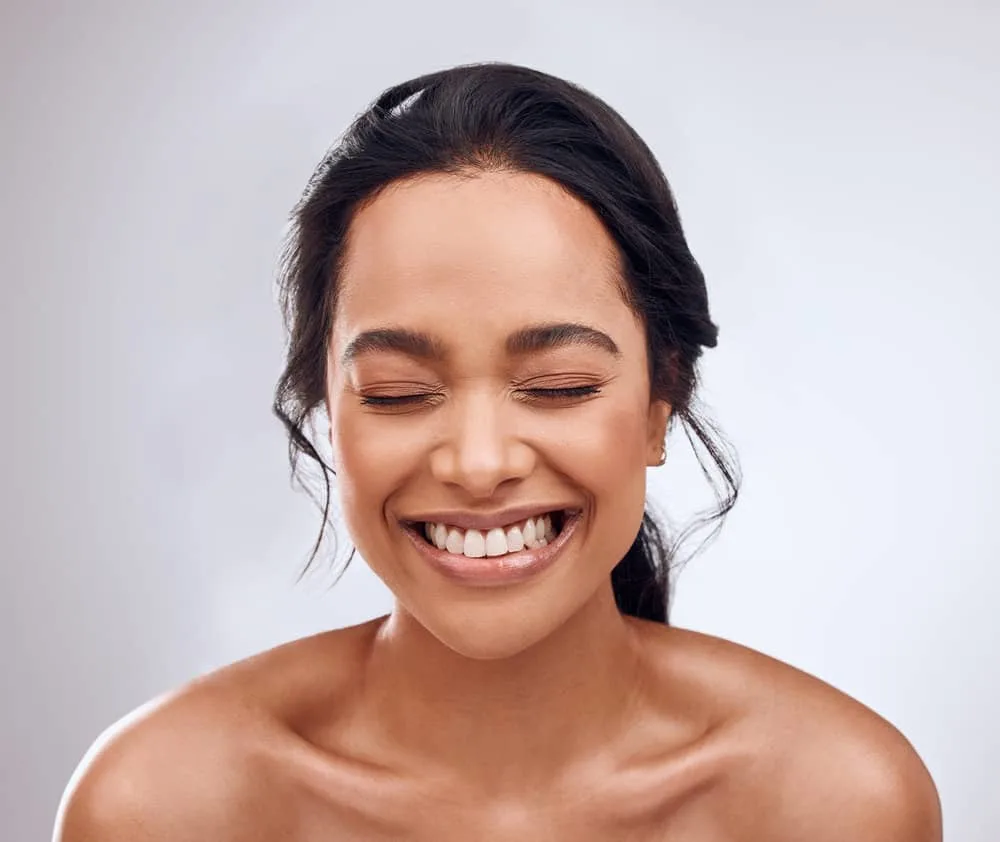 How Much Is a Keratin Treatment at a Salon for Short & Long Hair 6 A beautiful young female after washing her frizz-free hair with a clarifying shampoo and moisture-packed conditioner.