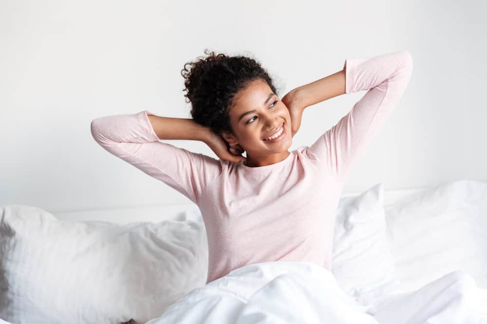 A young female that went to sleep with wet curly hair that was slightly dried by a microfiber towel.