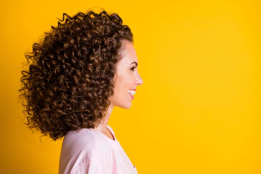 A happy woman after leaving a local hair salon to receive a keratin blow dry treatment.