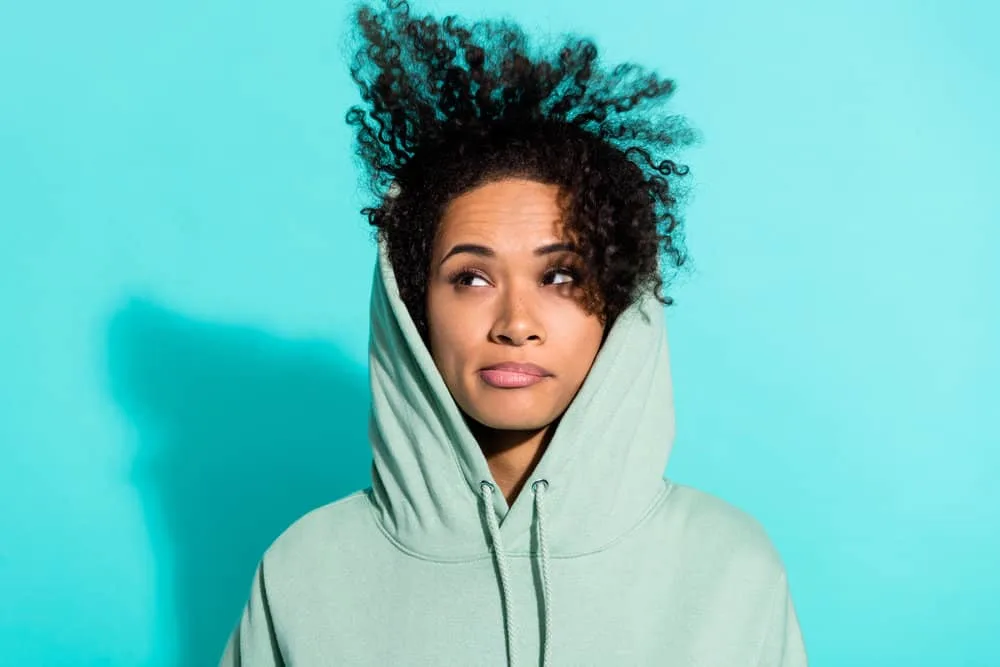 Does Sulfur8 Grow Hair? Help Dandruff? Does It Really Work? 4 A frustrated black girl ridding dandruff, thinning hair, and relieving itchy scalp issues by using mineral oil.