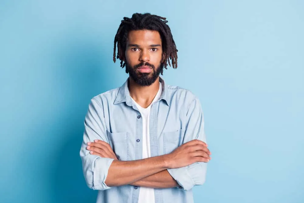Lil Baby Hairstyle: How to Get Lil Baby Dreads Step-By-Step 4 Nice guy with his arms crossed wearing braids undercut on messy textures with slightly different lengths.