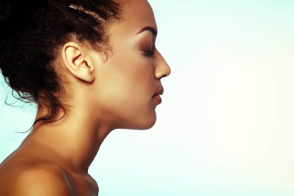 Young lady with beautiful skin suffering from hair loss as her hair begins to develop knots and further damage.