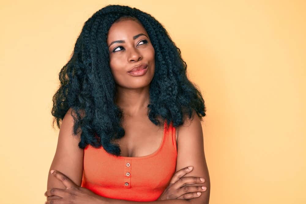 A beautiful African African woman wearing curls styled with Shea Moisture, not wig-specific products.