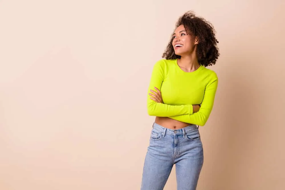 Is Love Beauty and Planet Good for Hair Care? Hair Growth? 13 A fun, charming young lady dressed in casual clothes with a light brown caramel skin color.