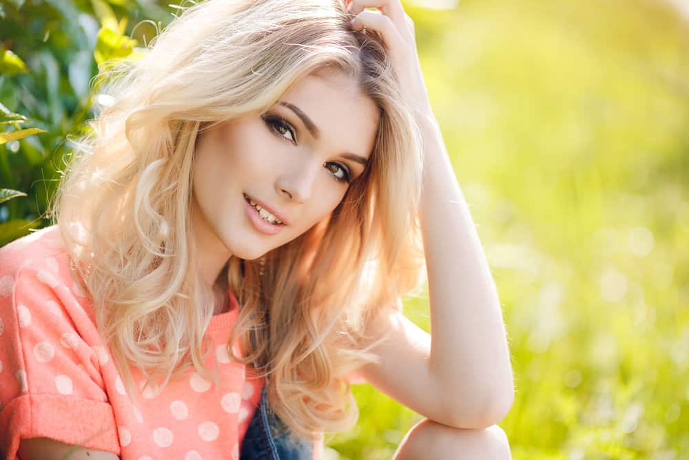 A young woman with lighter hair after using bleach and cruelty-free hair dye to create a lighter natural color.