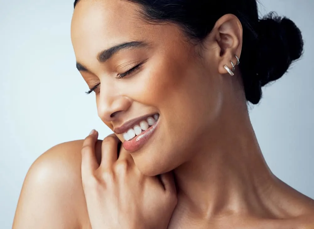How Much Is a Keratin Treatment at a Salon for Short & Long Hair 4 An African American lady wearing her longer hair in a ponytail updo secured by hair clips.