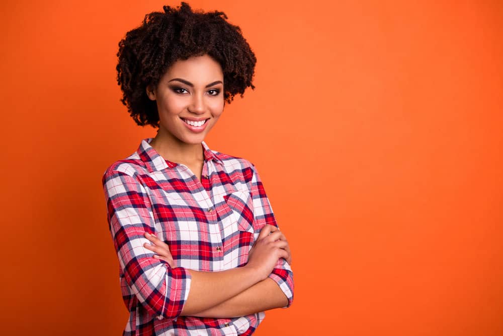 A nice-looking lady with thick hair styled with a deep conditioning hair mask and castor oil creating a looser curl.