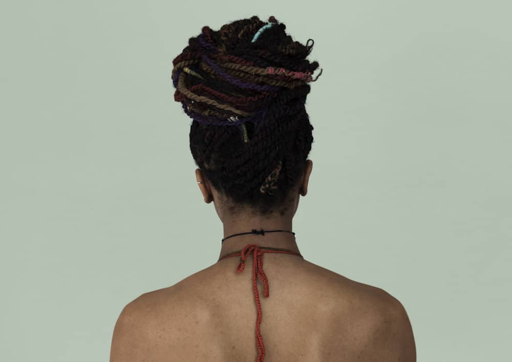 A black girl with buck shots (or tiny curls) on the back of her neck needs to be treated with curly hair products.