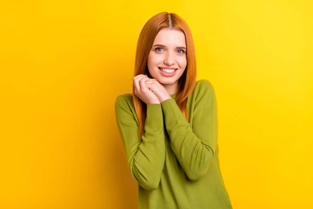 A female with medium texture fine hair styled with chemically processed oils and a wide tooth comb.