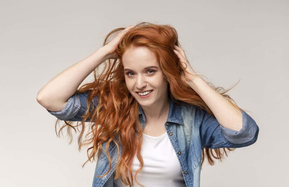 A female with a wavy curl pattern on her air drying wavy hair follicles styled with castor oil and a leave-in treatment.