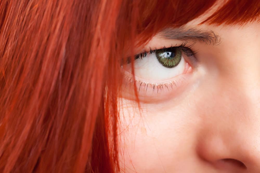 A lady with a unique red hair color mixed blue envy and pink fetish hair dyes together to create lovely red hair.