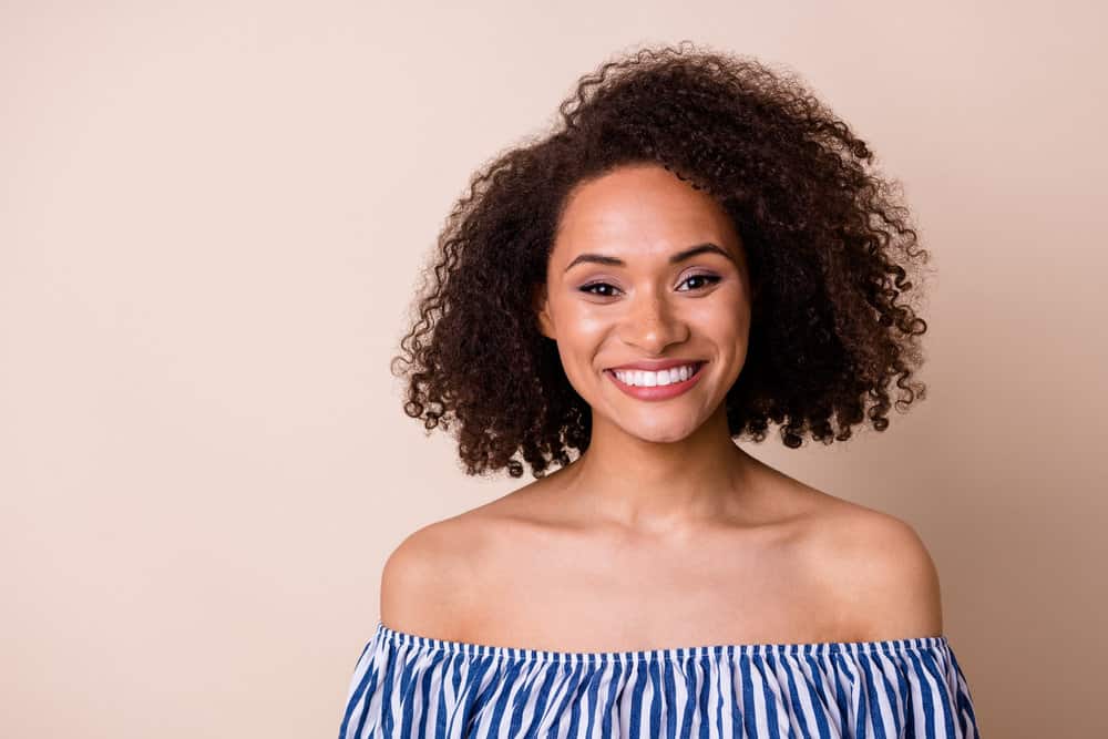 Cute black female with dark brown, fine hair that has been dyed a darker shade with medium brown hair dye.