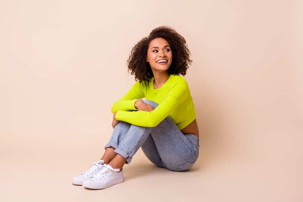 Nice looking young woman with natural curls styled with a Unilever brand hair product called LBP shampoo.