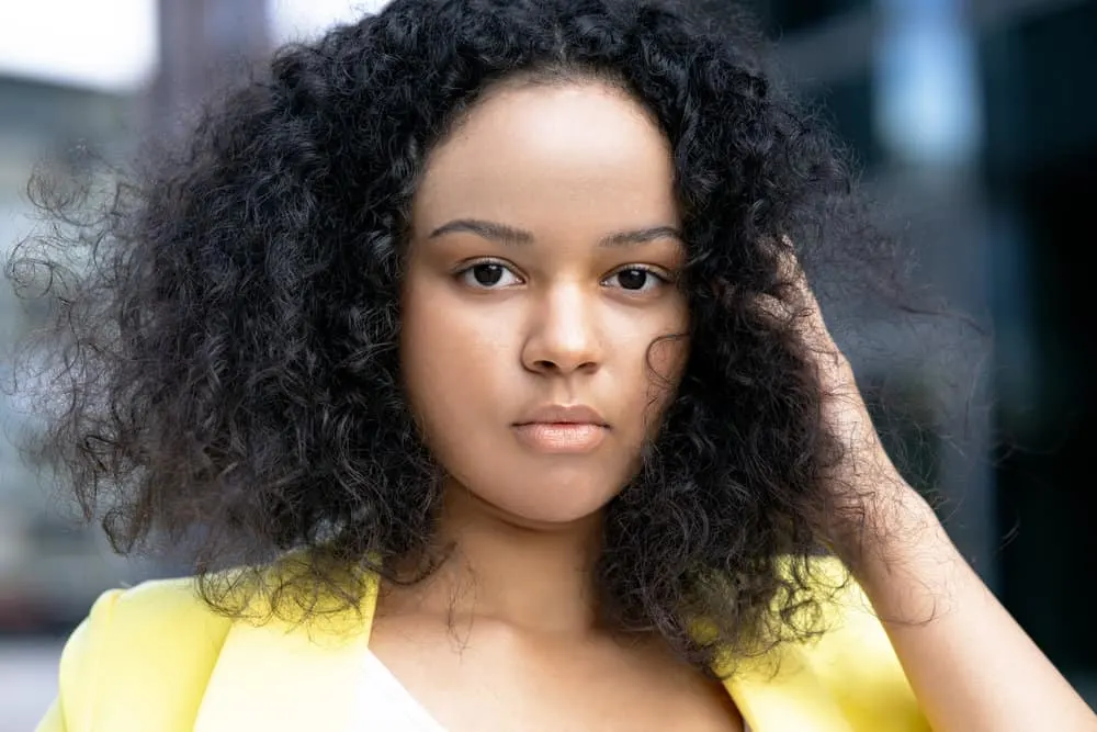 How Long Does a Keratin Treatment Last in Your Hair? 2 A cute black woman with silky smooth hair after getting a Brazilian keratin treatment with a formaldehyde-free formula.