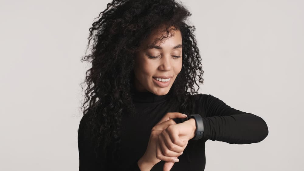 A young lady with medium hair thickness wearing a layered cut that keeps her hair healthy with anti-frizz products.