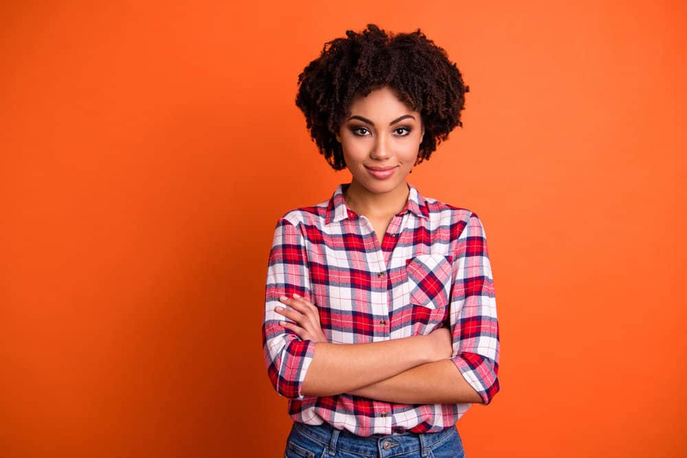 Light-skinned girl with curly long hair eliminated hair breakage by doing weekly scalp massages to increase blood flow.