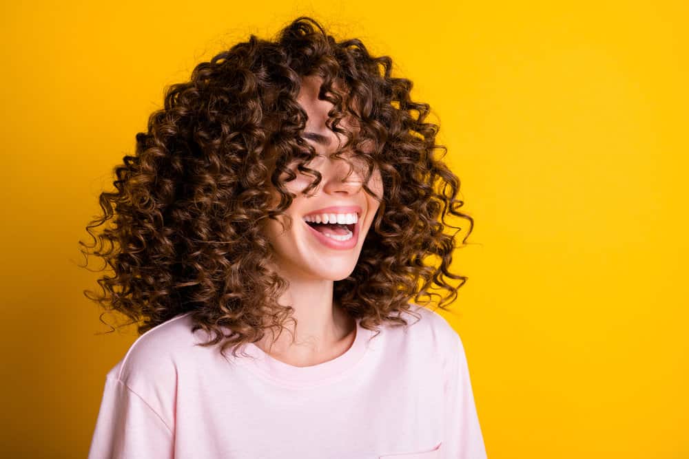 A cute white lady poses after straightening permed hair and having her wavy hair return after washing her hair.