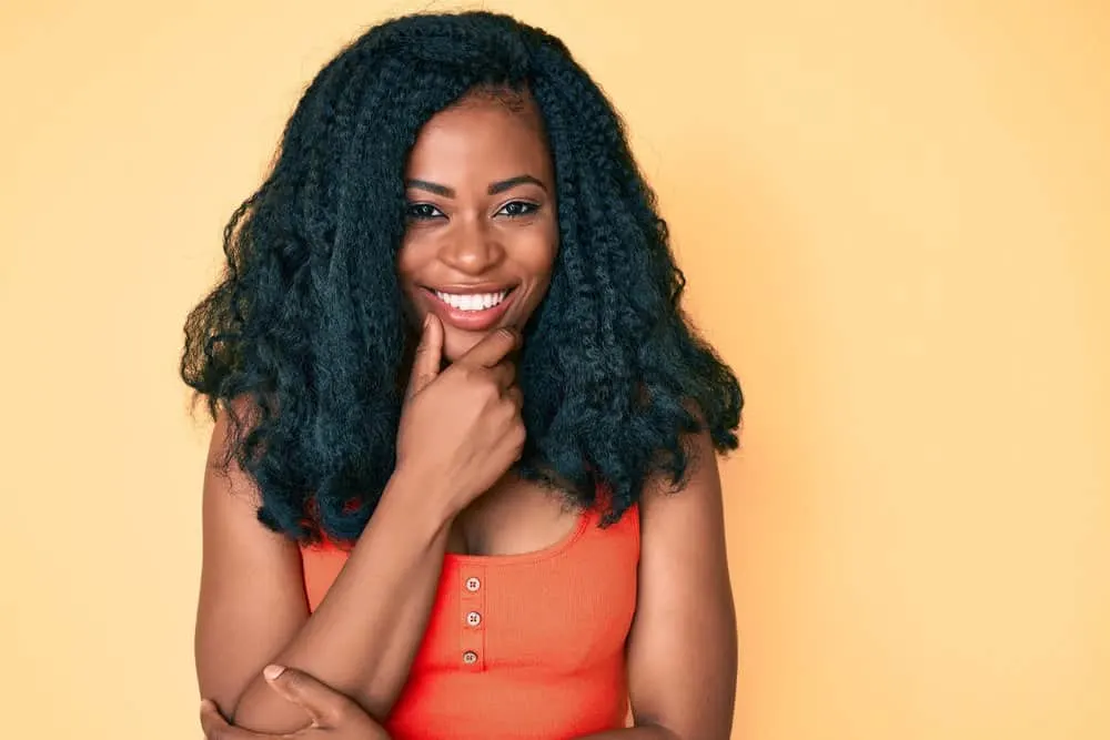 Can You Put Mousse on Synthetic Hair? Synthetic Wigs, Weaves & Braids? 2 A dark skin girl wearing human hair and synthetic hairs to create volume and a more natural look with foaming mousse.