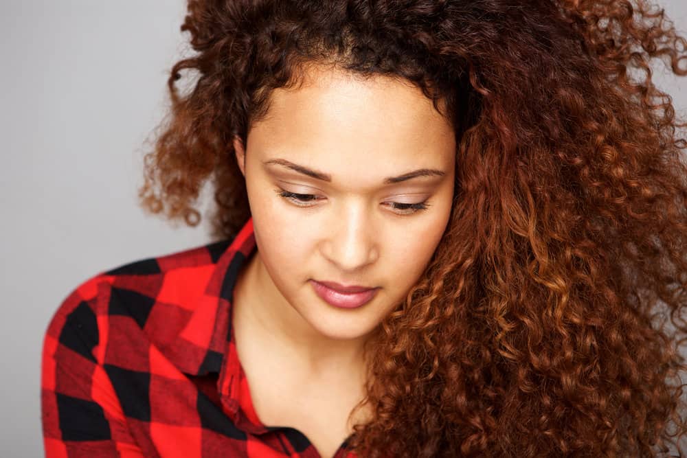 A young lady with a unique dyed hair color created by mixing semi-permanent hair dyes with demi-permanent color.