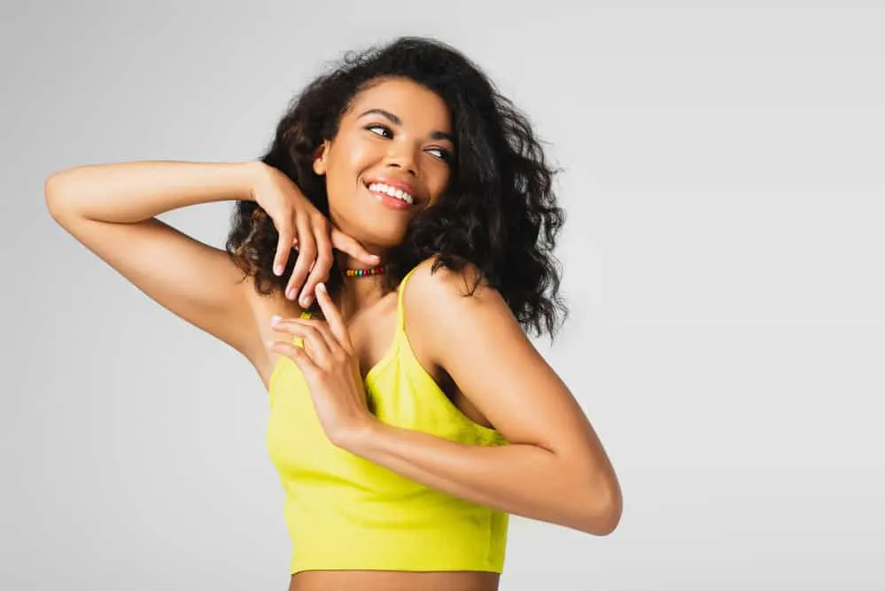 Does Not Washing Hair Cause Hair Loss, Thinning, & Breakage? 2 A black woman with thinning hair is now experiencing healthy hair growth after treating her fine hair gently.