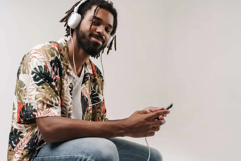 How to Make Locs Thicker Without Combining Them at the Root 10 An African American man with thicker locs has used several methods to maintain his dry hair.