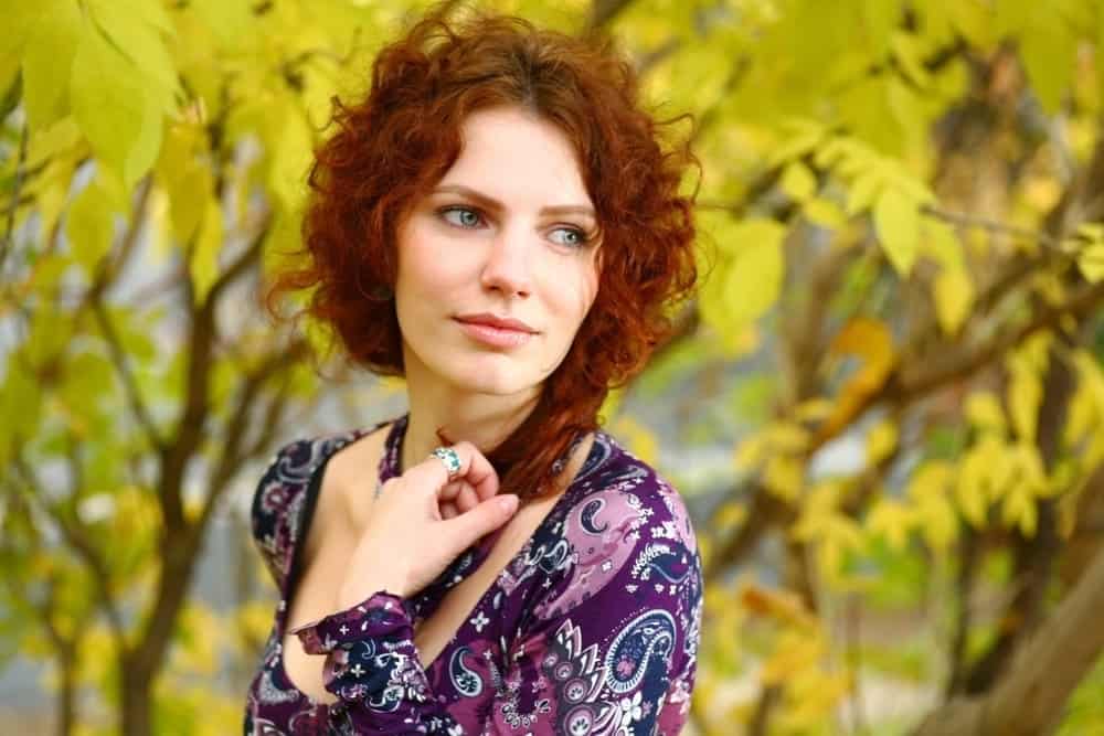 A young Caucasian female with dry hair, which is an issue that curly hair types struggle with frequently.