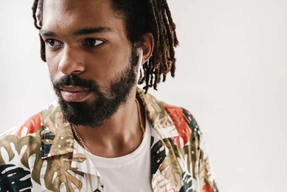 How to Make Locs Thicker Without Combining Them at the Root 1 A young black man with thick locs on his 4B natural hair texture oiled with jojoba oil to encourage healthier locs.