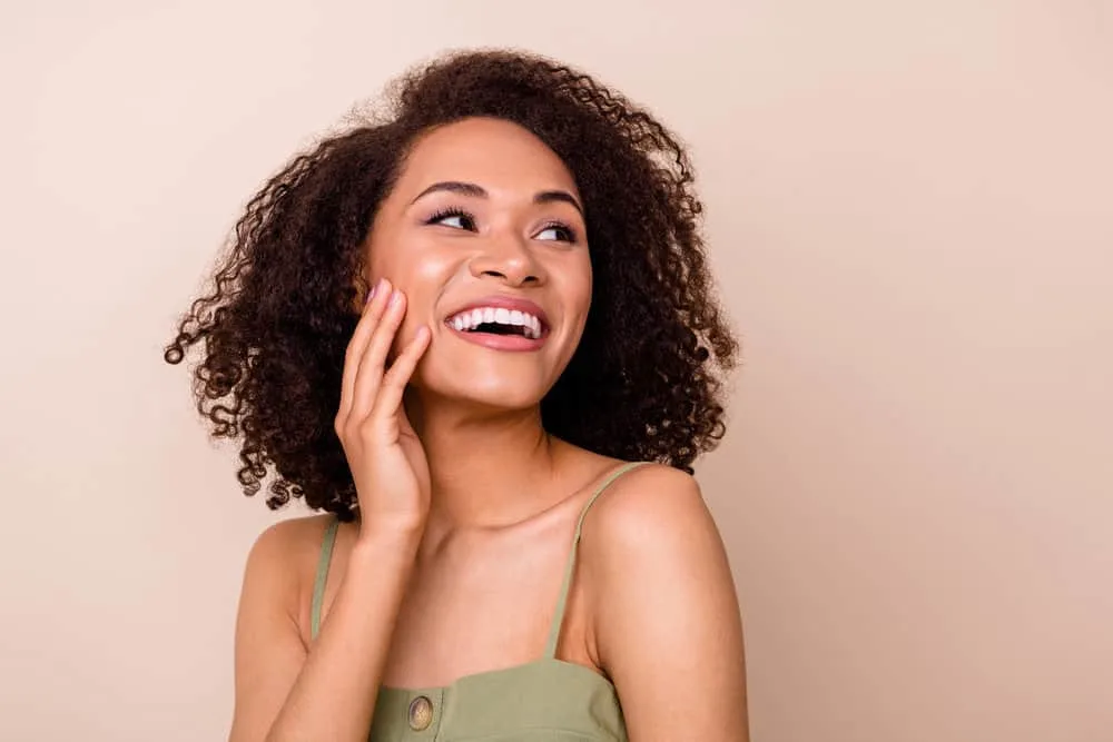 How Long Does Arctic Fox Last? How to Make It Last Longer 5 An African American female with natural curls dyed with Artic Fox dye and Curly Girl leave-in conditioner.