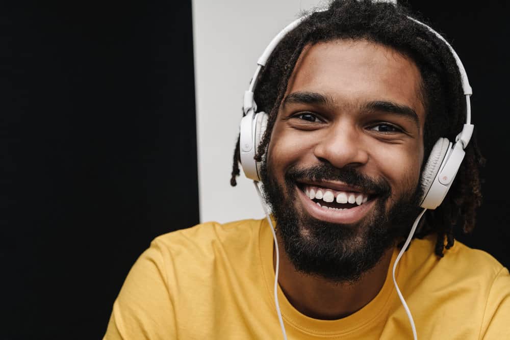 A black guy with clean hair after using shampoos and other hair products specifically designed for black hair types.