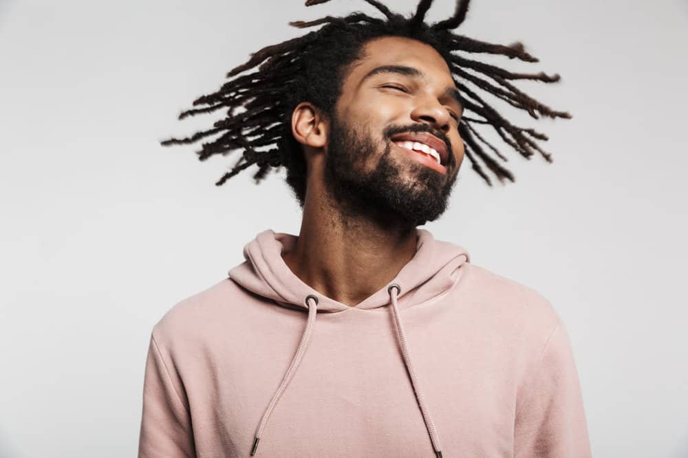 African American dude with natural locs created using the freeform hair locking method on her 4B hair type.