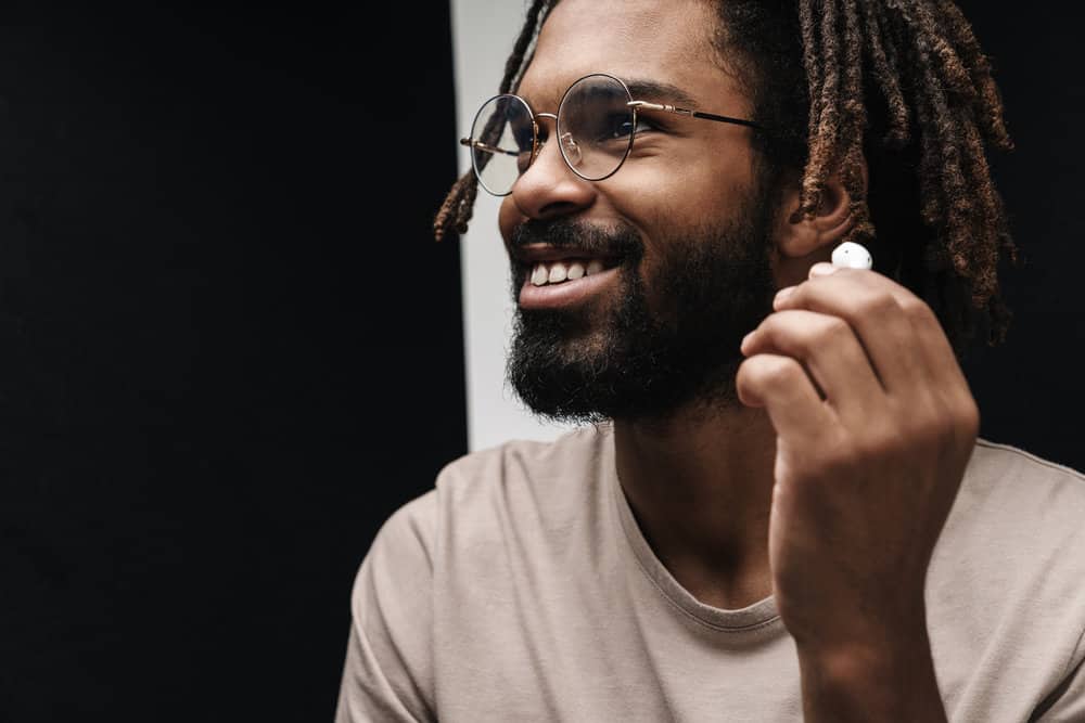 An African American man with naturally dry hair due to having 4B curly hair follicles has a low maintenance routine.