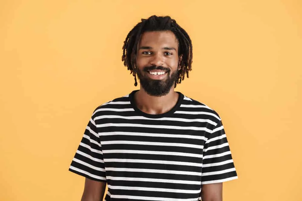 How Often Should I Wash My Locs? What if I Workout? 4 An African guy that's growing healthy dreadlocks is experiencing dry hair after deciding to wash locs daily.
