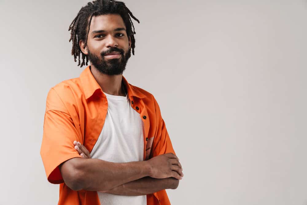 Optimistic African American guy wondering if you can use dreads to cover natural baldness in the military.