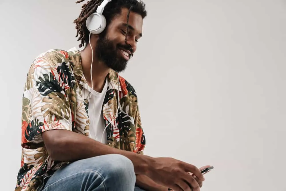 How to Make Locs Thicker Without Combining Them at the Root 9 A black guy with thicker locs has dark brown hair dye covering his whole head.