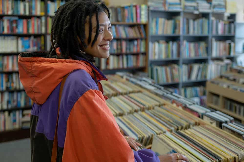 A black female with growing locs uses scalp massages to encourage new growth and reduce stress.