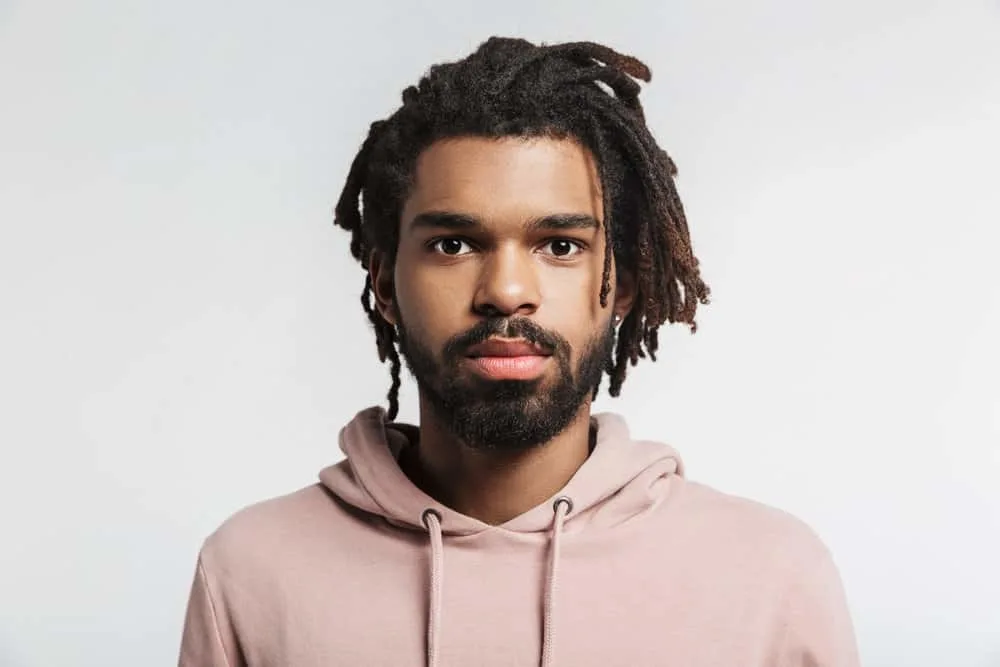 How Much Do Starter Locs Cost? Should You DIY Starter Locs? 4 A 30-year-old black guy showing off the growth from his baby locs to mature dreads styled with coconut oil.
