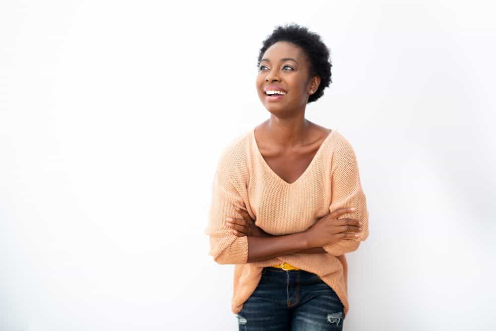 Black lady with a medium-brown skin color starting her natural hair journey after a big chop.