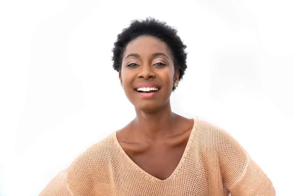 What Is 4C Hair? How To Take Care of It, Styles, and Products 1 A black lady with coily hair according to a particular hair typing system and kinky hair according to a different system.