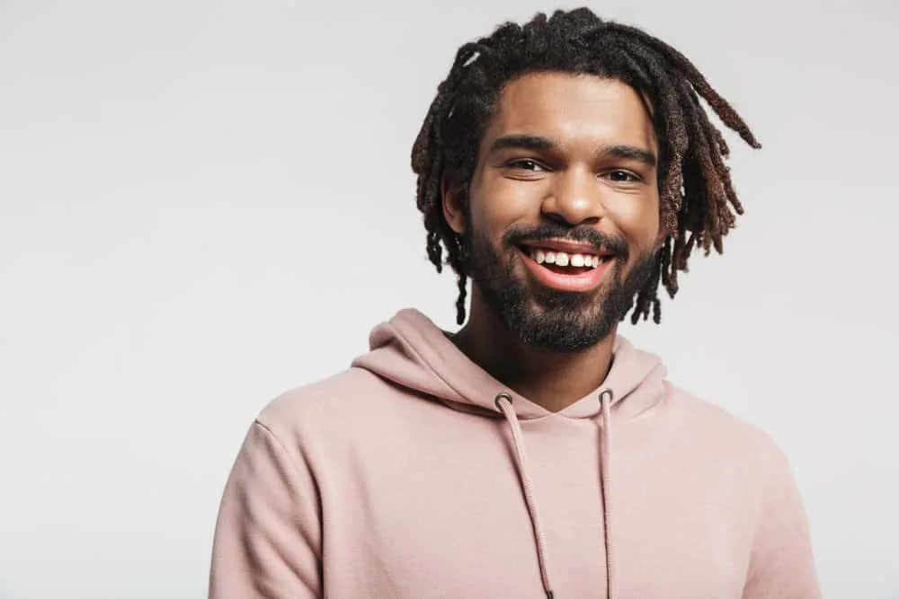 How Much Do Starter Locs Cost? Should You DIY Starter Locs? 5 An African male with thin hair created shoulder-length freeform locs using the latch hook method for maintenance.