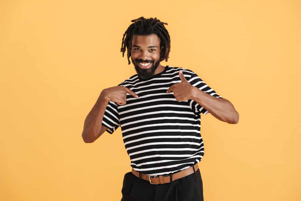 African American man with brittle hair after waiting about a week between washing his dreadlocks.