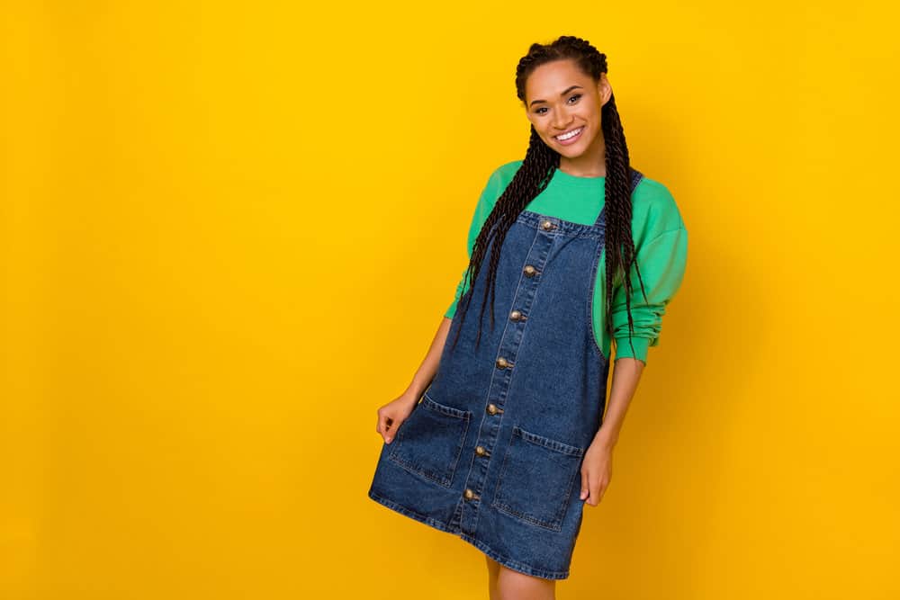 A gorgeous female with flat-ironed straight hair that has been braided with french and dutch braids.